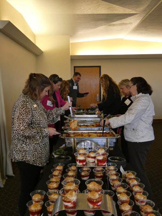 Conference attendees helping themselves to food from a table